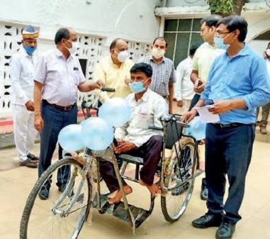 The Weekend Leader - Yogi gives tricycle to man with disability