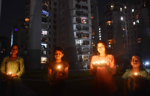 Detractors smell political one-upmanship in PM's 'lights off-lamps on' event 