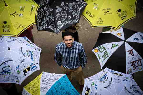 An umbrella to maintain social distancing in Kerala villages